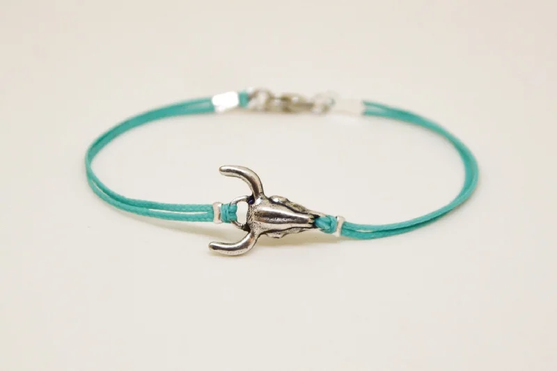 Men's bracelet with silver bull charm, turquoise cord, bull skull